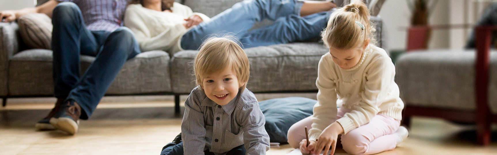 Family smiling and relaxing in their living room