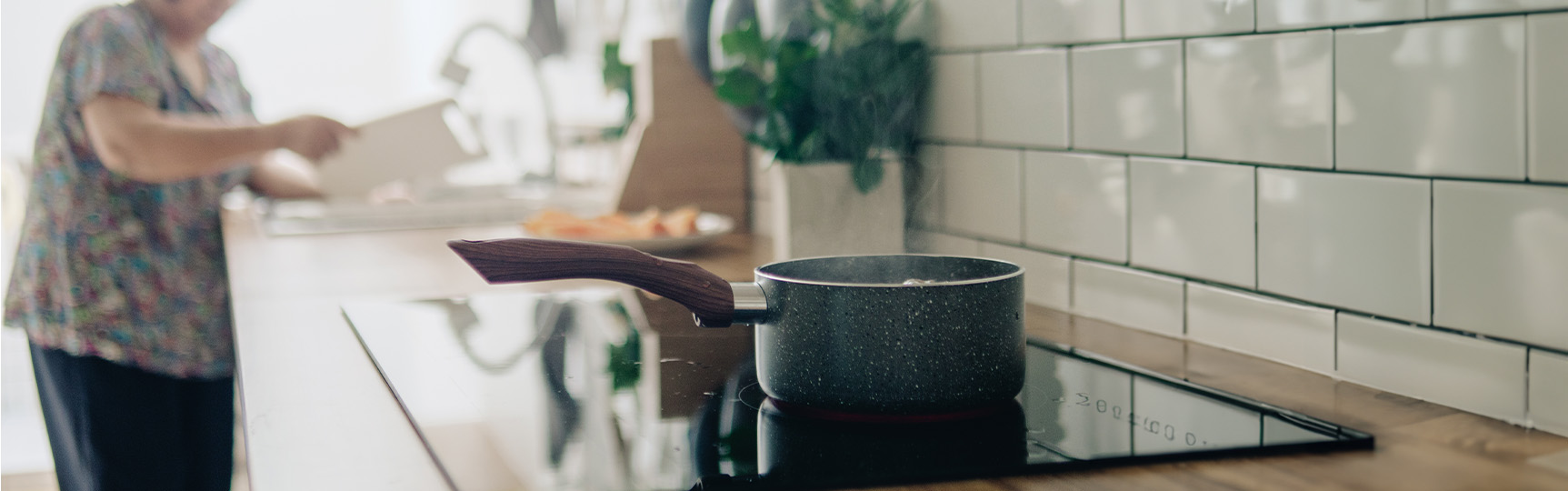 Woman preparing food on an electric stovetop