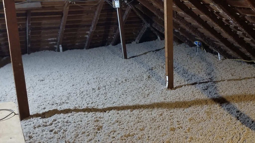 Attic view showing clean insulation and air sealing