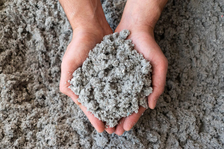 Hands holding cellulose insulation