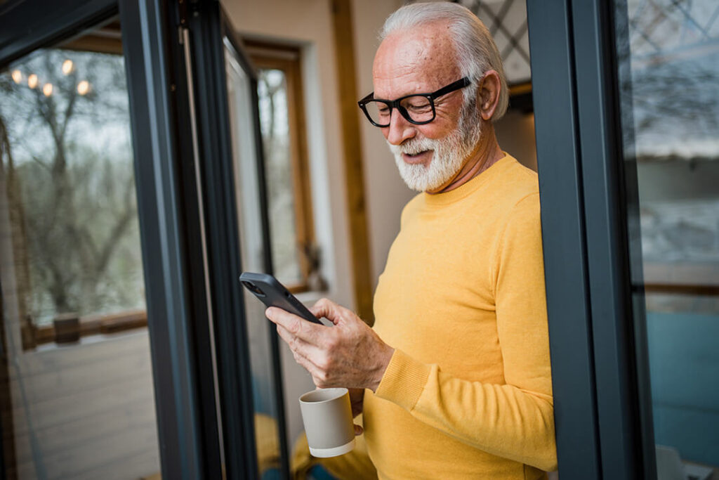 A middle-aged man looks at his phone